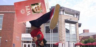 Giant student ID is spun in a sign-twirling fashion outside the CC